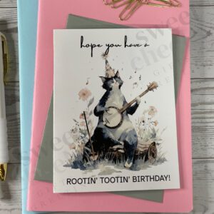 Greating card featuring Rootin' Tootin' Birthday Country cat playing blue grass banjo in the woods