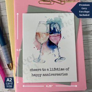 Greeting card featuring two wine glasses anniversary card with message "cheers to a lifetime of happy anniversaries"