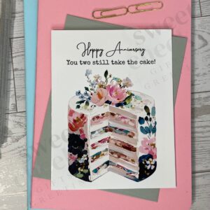 Greeting card with top of the cake and message "Happy Anniversary you two still take the cake!"
