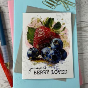 Greeting card featuring strawberries and blueberries with message "you are so berry loved"