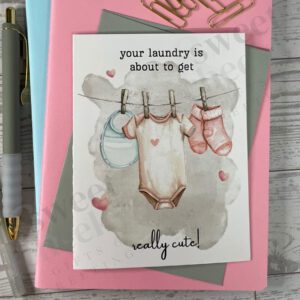Greeting card featuring cute baby laundry hanging to dry on a line with message "your laundry is about to get really cute!"