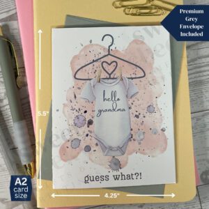 Cute peach pink new baby greeting card announcement featuring onsie with text "hello grandma" and below "guess what?!"