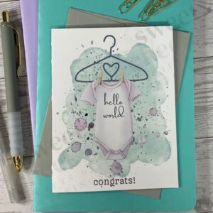 Cute green new baby greeting card announcement featuring onsie with text "hello world" and below "congrats!"