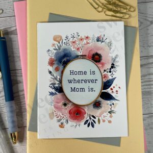 Greeting card with message "home is wherever mom is." on needlepoint embroidery hoop.