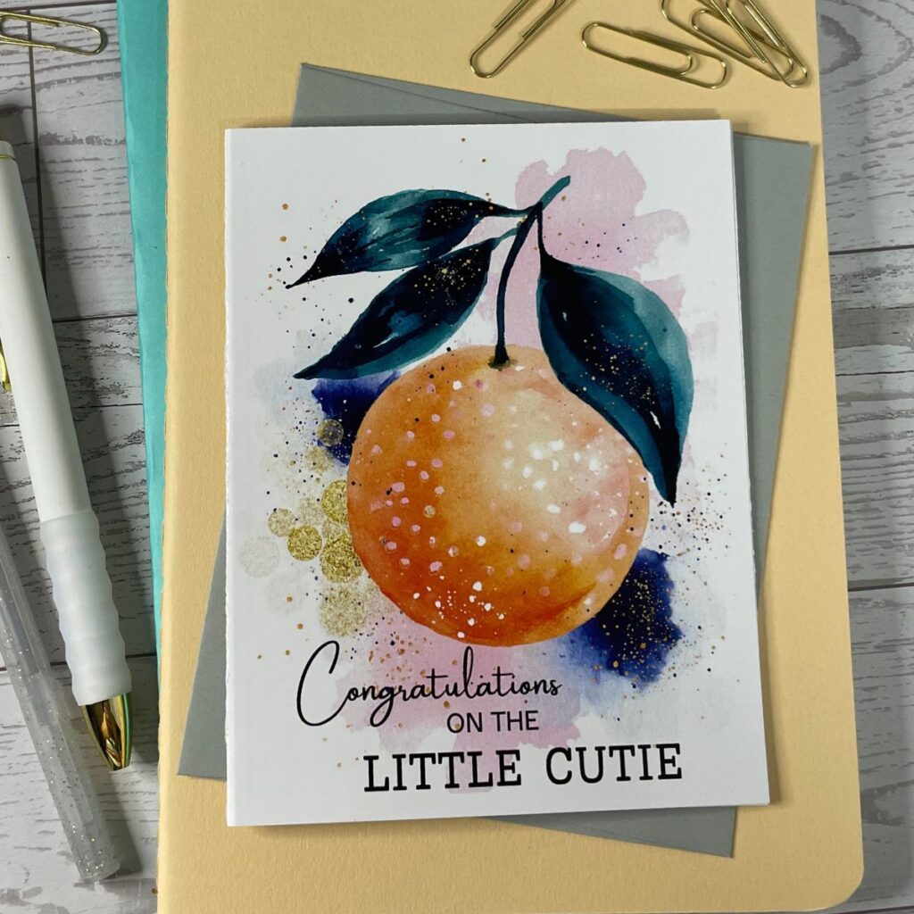Greeting card featuring a cute watercolor tangerine and the message for parents "Congratulations on the little cutie"